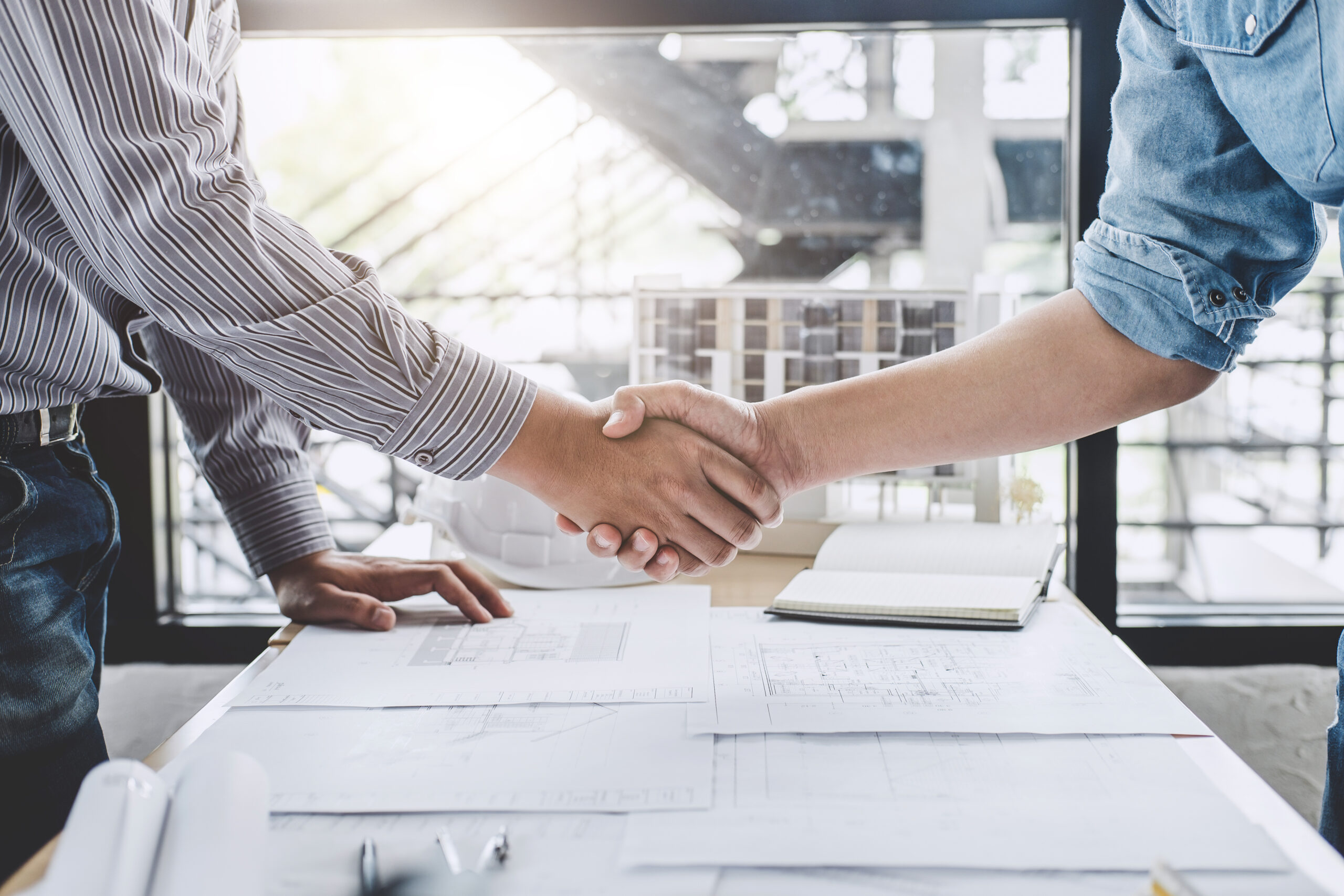 Engineer or architect meeting for project handshake after consultation
